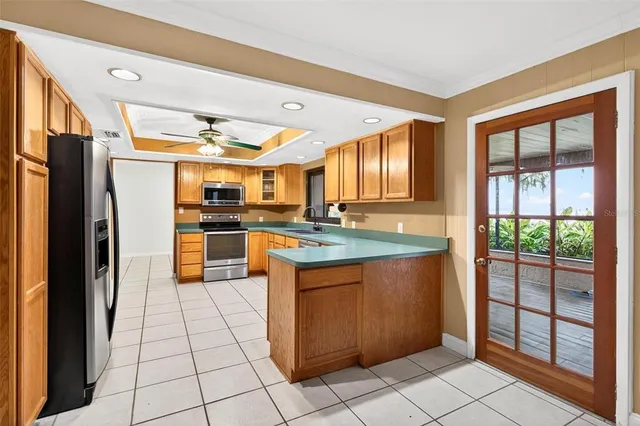 an empty room with windows and ceiling fan