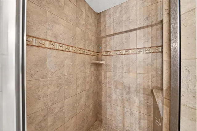 an aerial view of ocean and residential houses with outdoor space