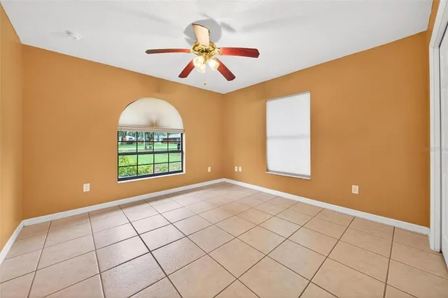 a view of a house with a yard and tree s