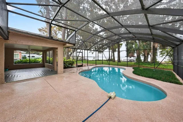 a view of an empty room and chandelier fan