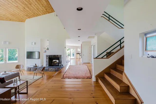 a living room with furniture a fireplace and a large window
