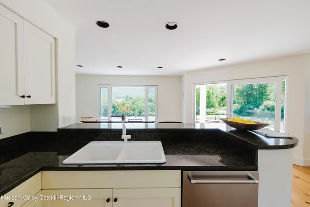 a view of a white house with a yard