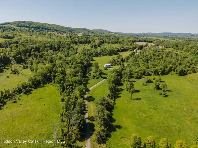 a view of a house with swimming pool and yard
