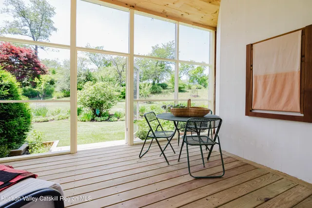 a backyard of a house with a yard and outdoor seating