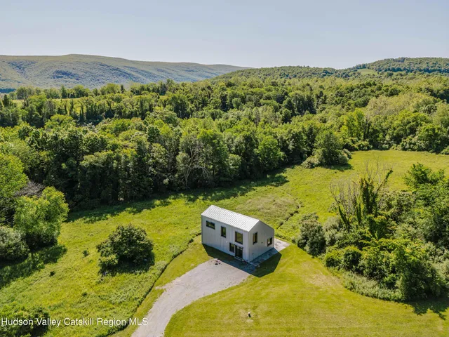 a living room with furniture a large window and a fireplace