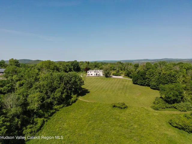a view of a patio with table and chairs and wooden floor