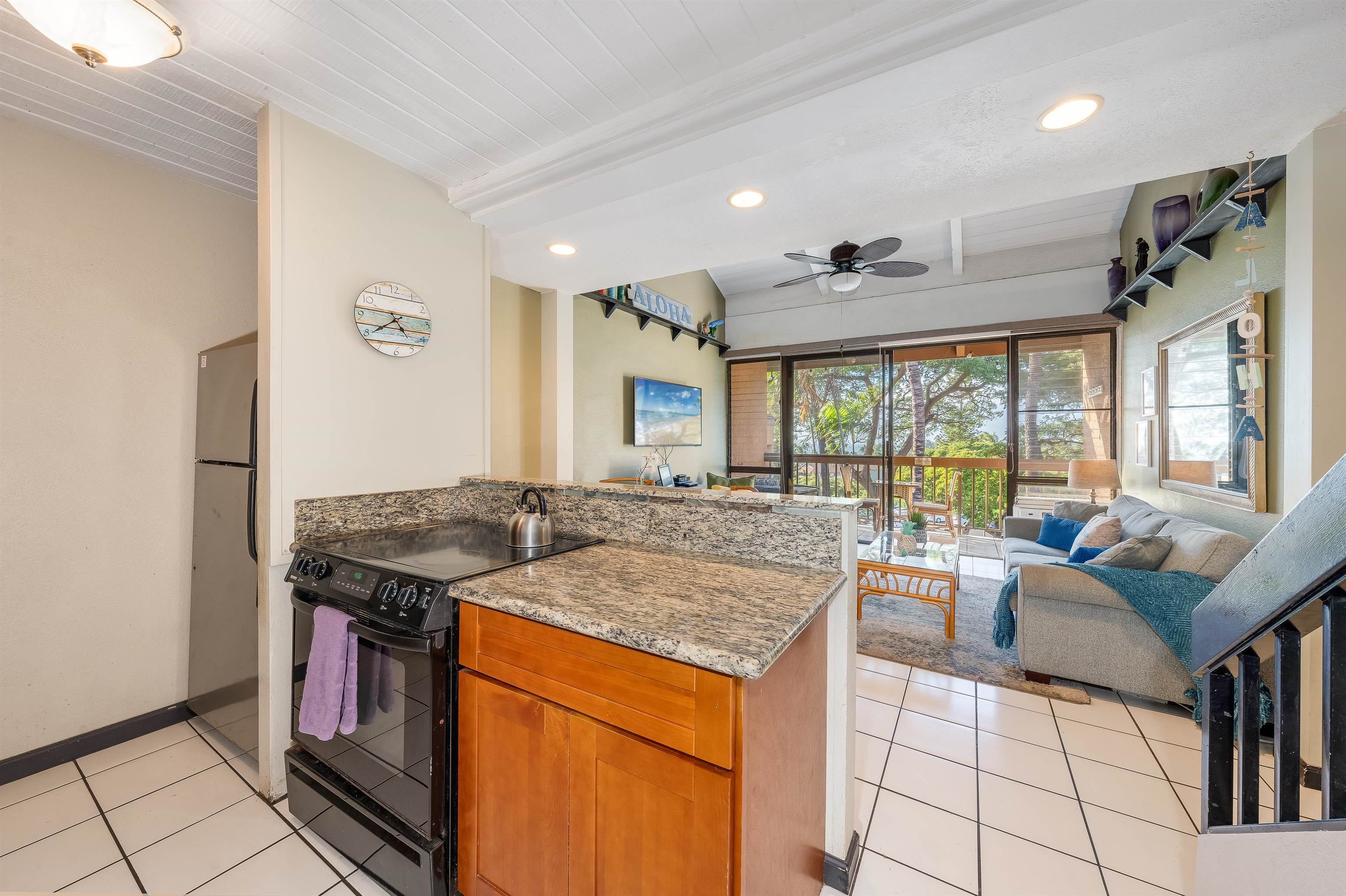 2191 South Kihei Road, Unit 2413 Kihei, HI 96753 - Photo 12 of 34 a kitchen with stainless steel appliances granite countertop a stove and a refrigerator