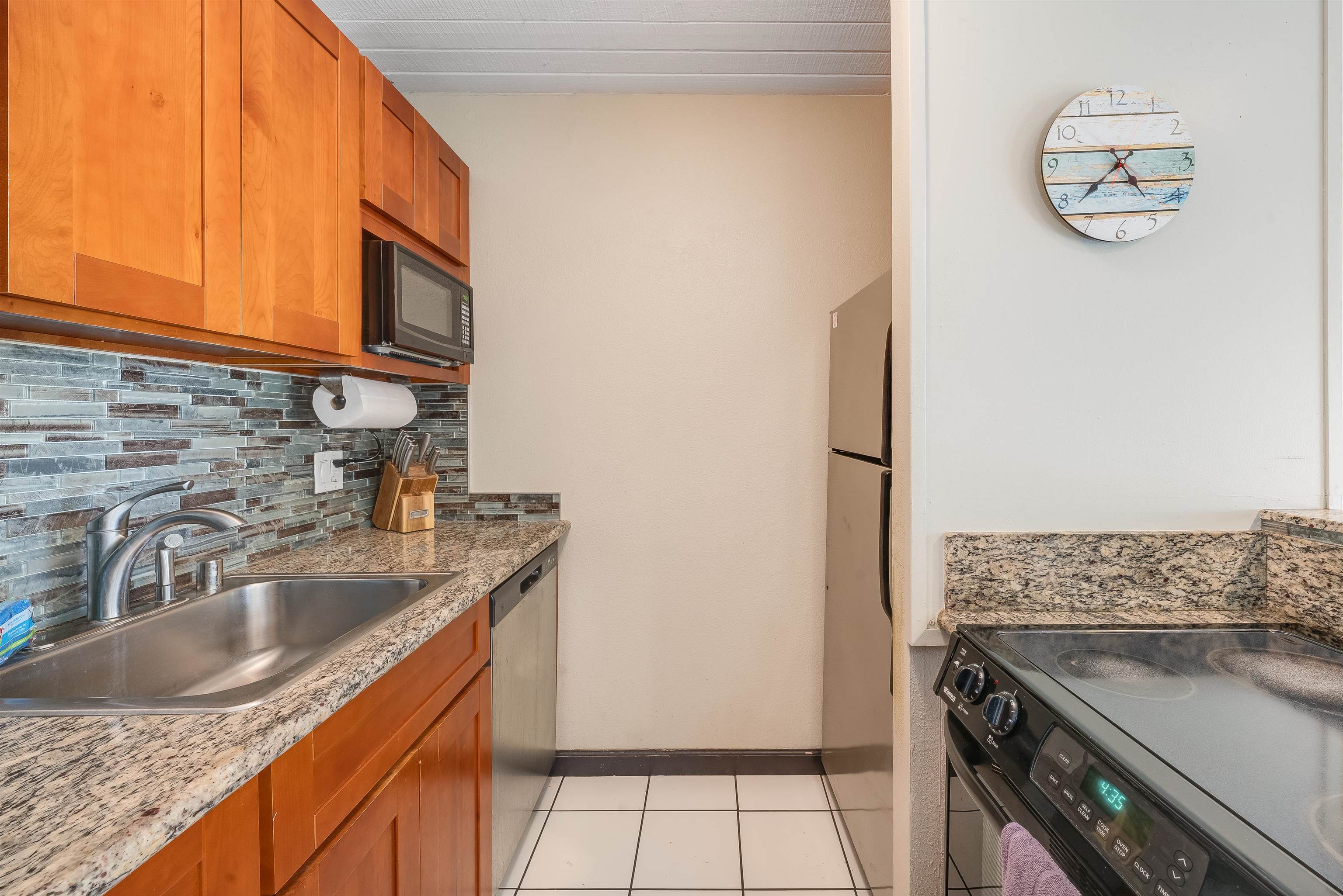 2191 South Kihei Road, Unit 2413 Kihei, HI 96753 - Photo 13 of 34 a kitchen with stainless steel appliances granite countertop a sink stove and refrigerator