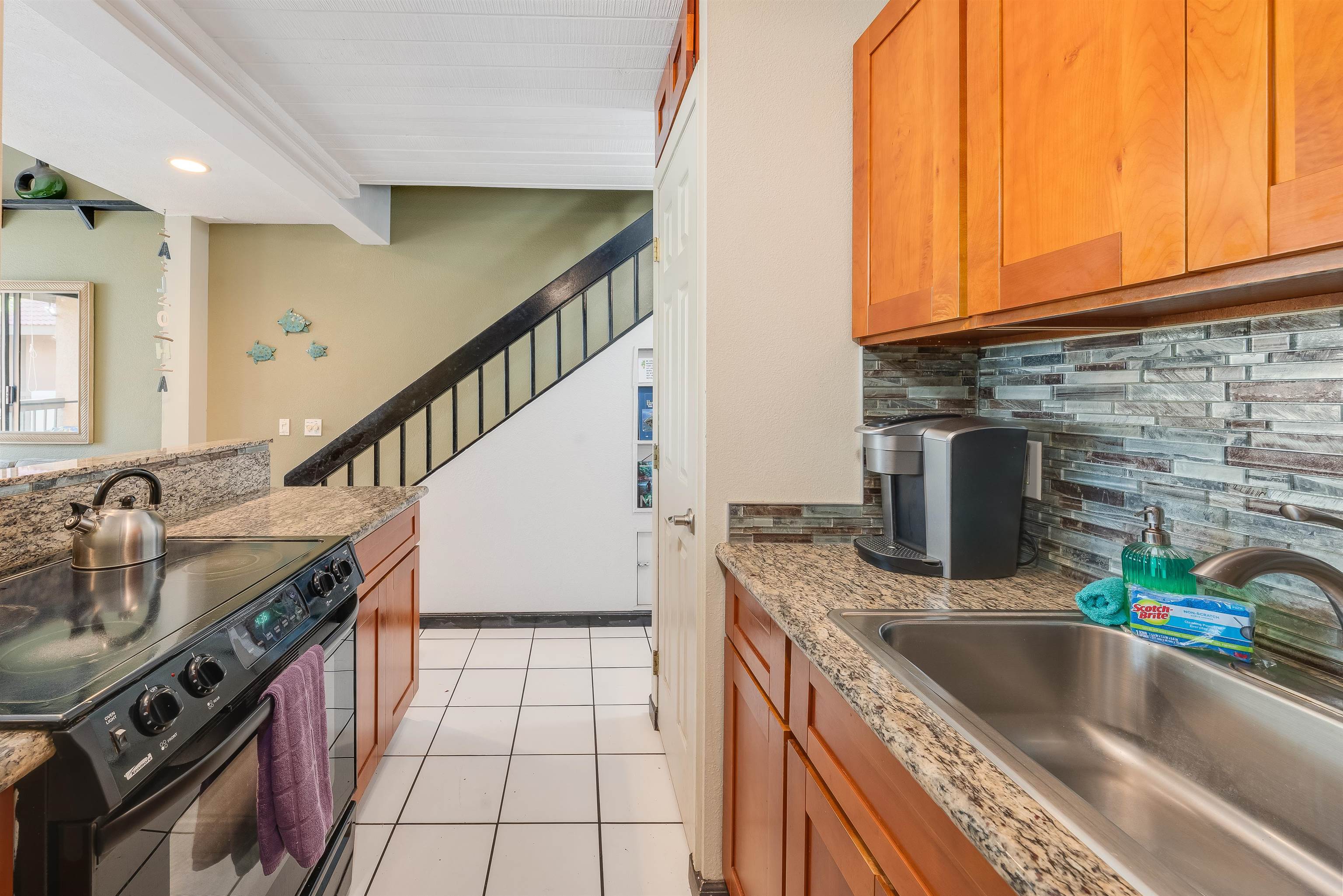 2191 South Kihei Road, Unit 2413 Kihei, HI 96753 - Photo 15 of 34 a kitchen with stainless steel appliances granite countertop a sink a stove and a counter space