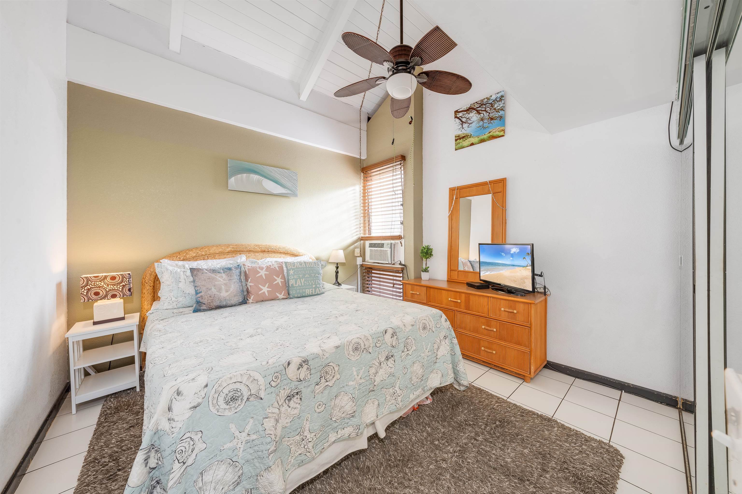 2191 South Kihei Road, Unit 2413 Kihei, HI 96753 - Photo 17 of 34 a bedroom with a bed dresser and a window