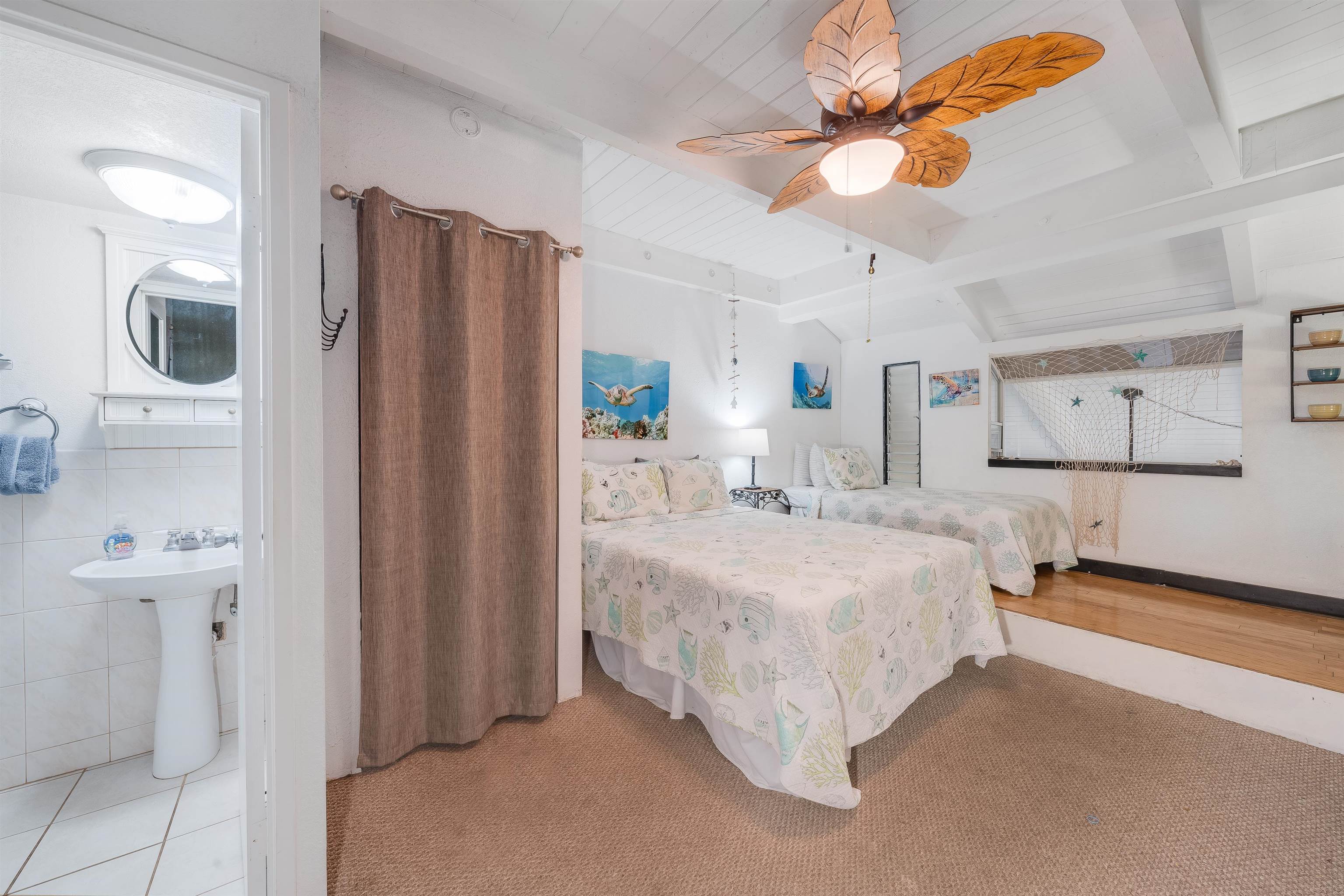 2191 South Kihei Road, Unit 2413 Kihei, HI 96753 - Photo 20 of 34 a spacious bedroom with a bed and a chandelier