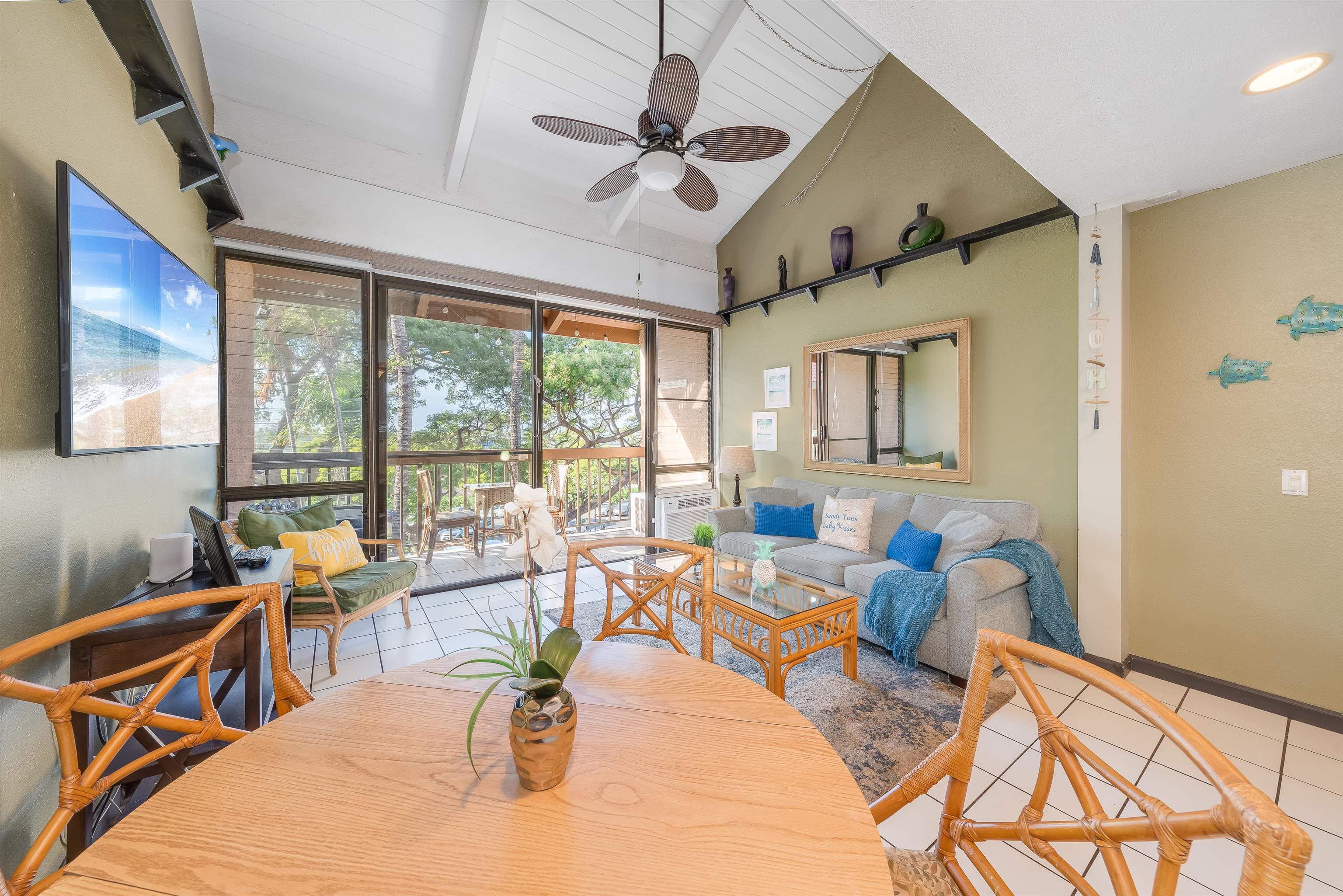 2191 South Kihei Road, Unit 2413 Kihei, HI 96753 - Photo 3 of 34 a living room with furniture a ceiling fan and a large window