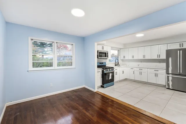 a kitchen with stainless steel appliances a refrigerator sink and cabinets