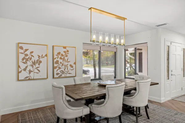 a view of a dining room with furniture wooden floor and chandelier