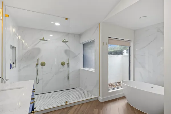 a bathroom with a bathtub and a shower