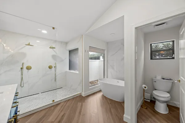 a bathroom with a toilet and a shower