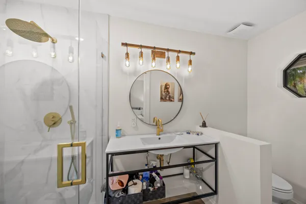 a view of a bathroom with a sink and a mirror