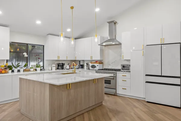 a kitchen with stainless steel appliances granite countertop a sink stove and refrigerator