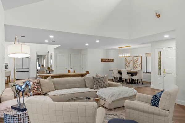 a living room with furniture and a dining table