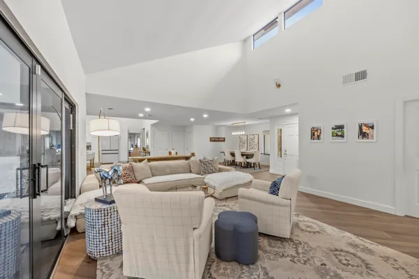 a living room with furniture and a wooden floor