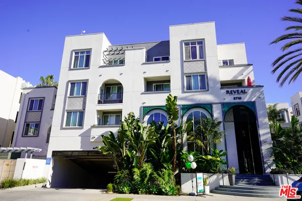 a front view of residential houses with outdoor space and seating area