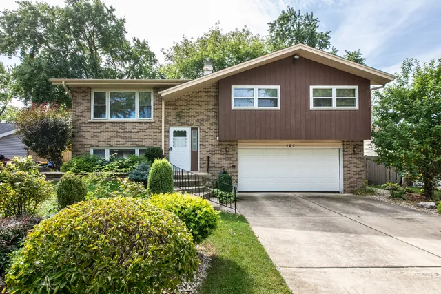 a front view of a house with a garden