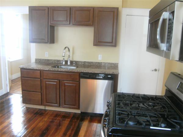 21 1/2 Durham Street, Unit 4 Somerville, MA 02143 - Photo 1 of 1 a kitchen with stainless steel appliances granite countertop a stove and a sink