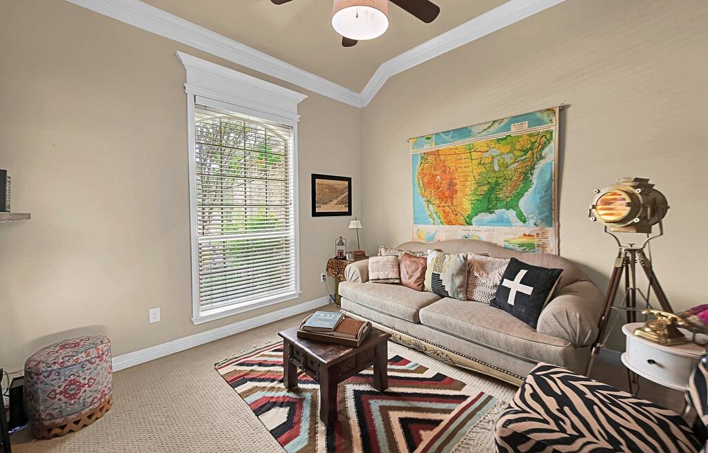 550 Hunton Lane Robinson, TX 76706 - Photo 21 of 35 Carpeted living room featuring ornamental molding and ceiling fan