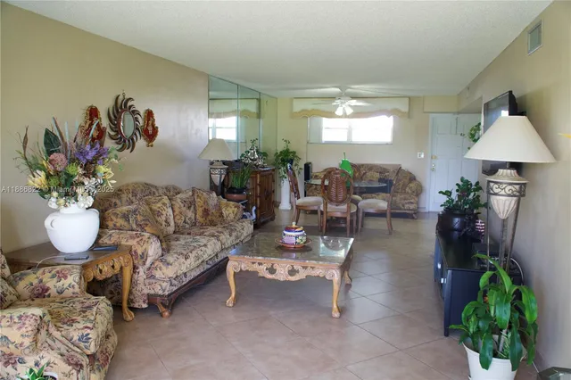 a living room with furniture a chandelier and a window
