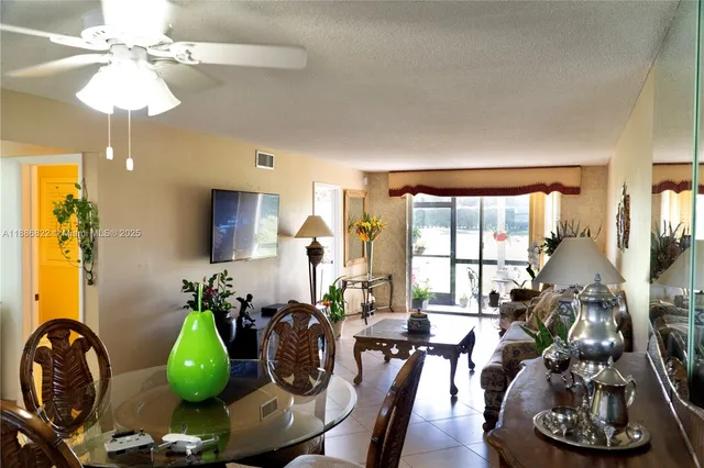 a living room with furniture a chandelier and a large window