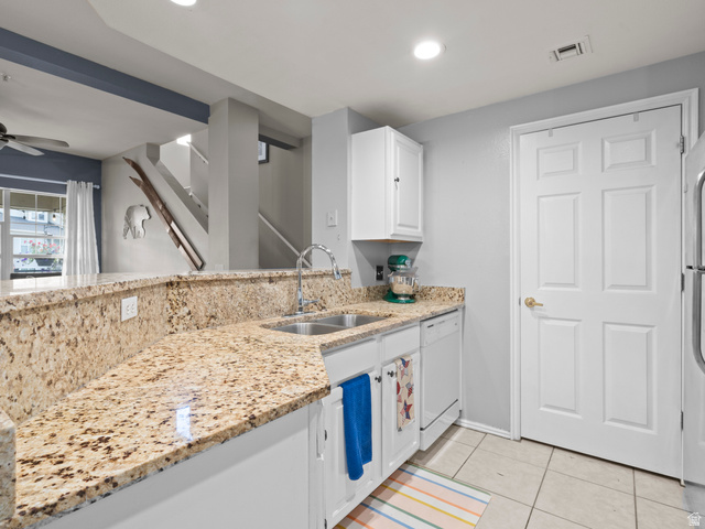 900 Bitner Road, Unit D 34 Park City, UT 84098 - Photo 19 of 25 Kitchen featuring white cabinetry, ceiling fan, dishwasher, light stone countertops, and light tile patterned floors
