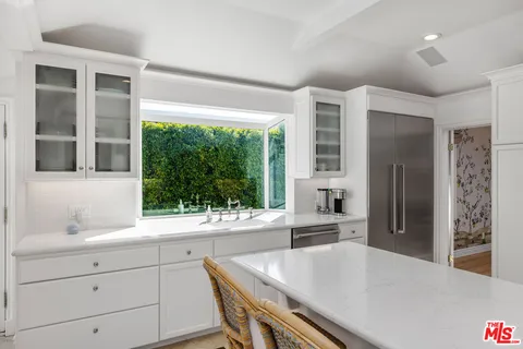 a kitchen with a table chairs and refrigerator