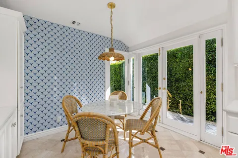 a view of a dining room with furniture large windows and wooden floor