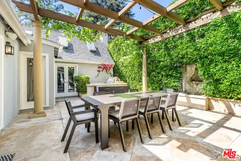 a view of a patio with a table and chairs