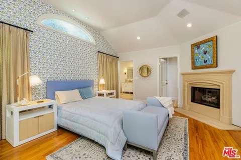 a spacious bedroom with a bed and couch