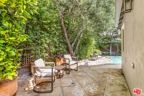 a view of a backyard with sitting area