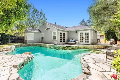 a view of a backyard with swimming pool