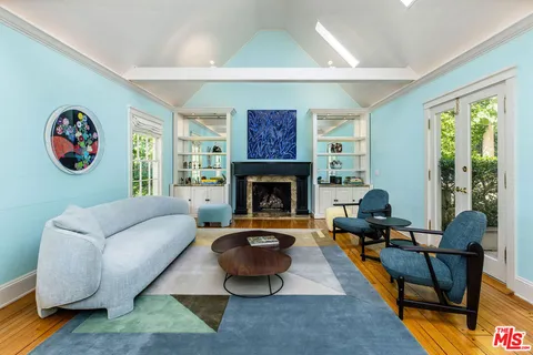 a living room with furniture a rug and a fireplace
