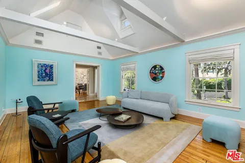 a living room with furniture rug and window