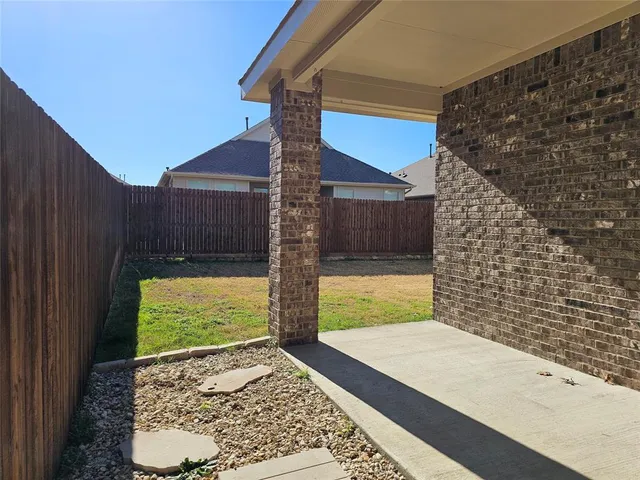a view of house with backyard and trees