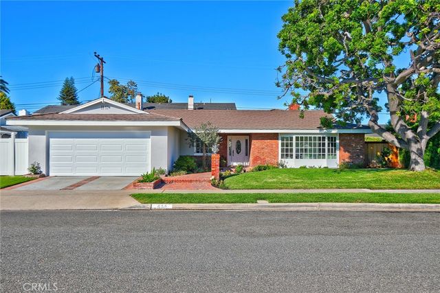 a front view of house with outdoor space and trees around