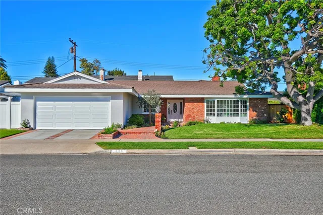 a front view of house with outdoor space and trees around