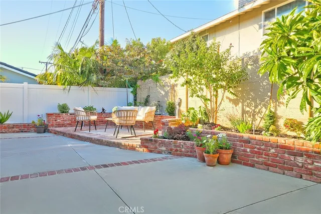 a view of a patio with table and chairs under an umbrella