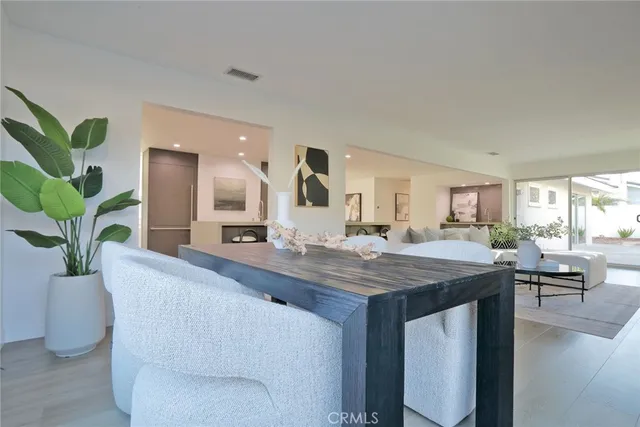 a dining room with furniture and potted plant