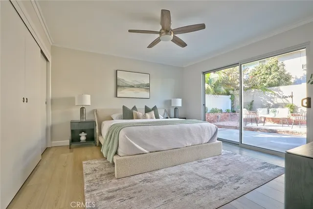 a spacious bedroom with a bed a large window with outer view and couch