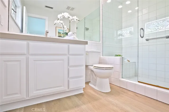a bathroom with a toilet sink and shower