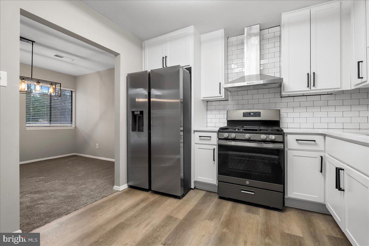 19030 Mills Choice Road, Unit 6 Gaithersburg, MD 20886 - Photo 11 of 21 a kitchen with stainless steel appliances granite countertop a refrigerator stove and sink