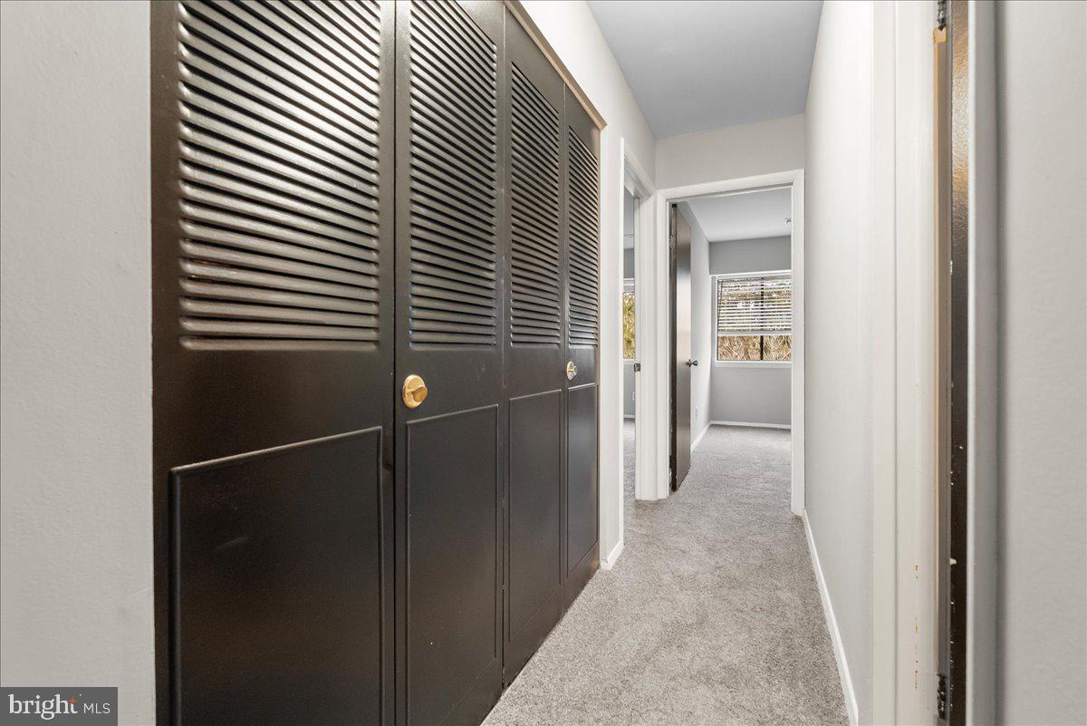 19030 Mills Choice Road, Unit 6 Gaithersburg, MD 20886 - Photo 12 of 21 a view of a hallway with wooden shelves