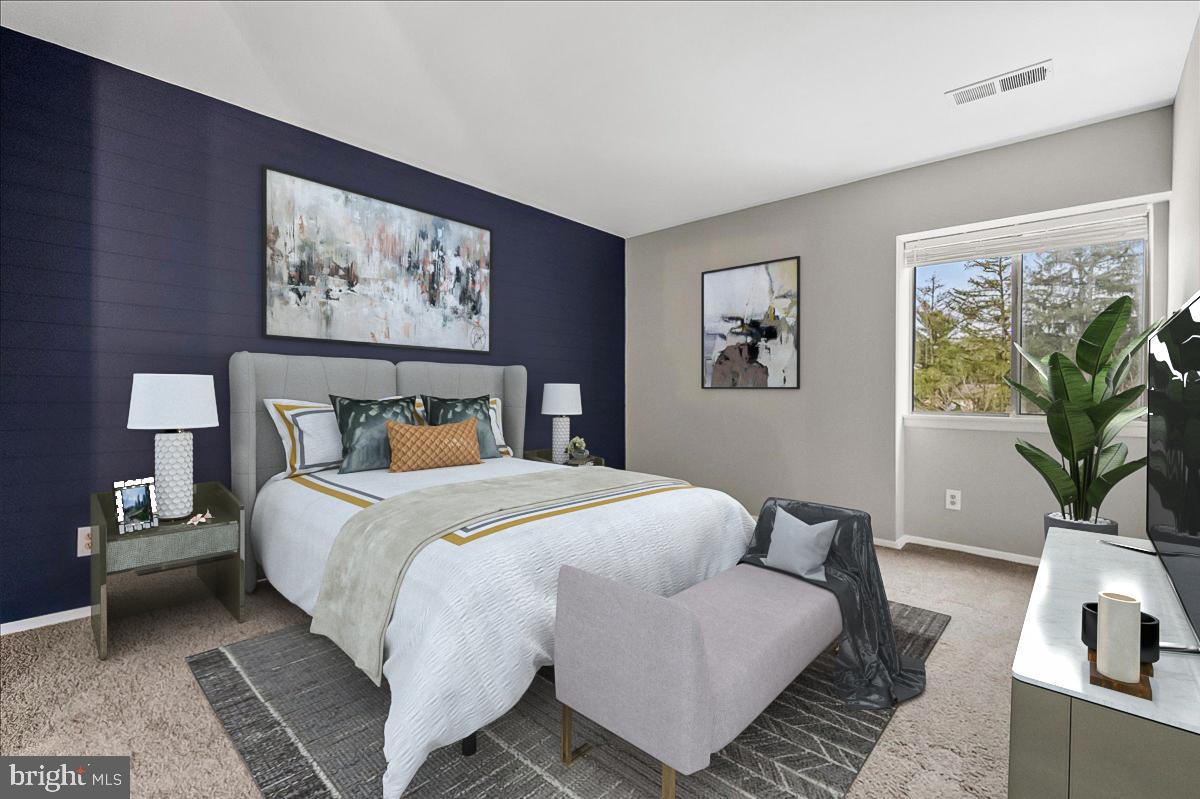 19030 Mills Choice Road, Unit 6 Gaithersburg, MD 20886 - Photo 17 of 21 a bedroom with bed and a couch