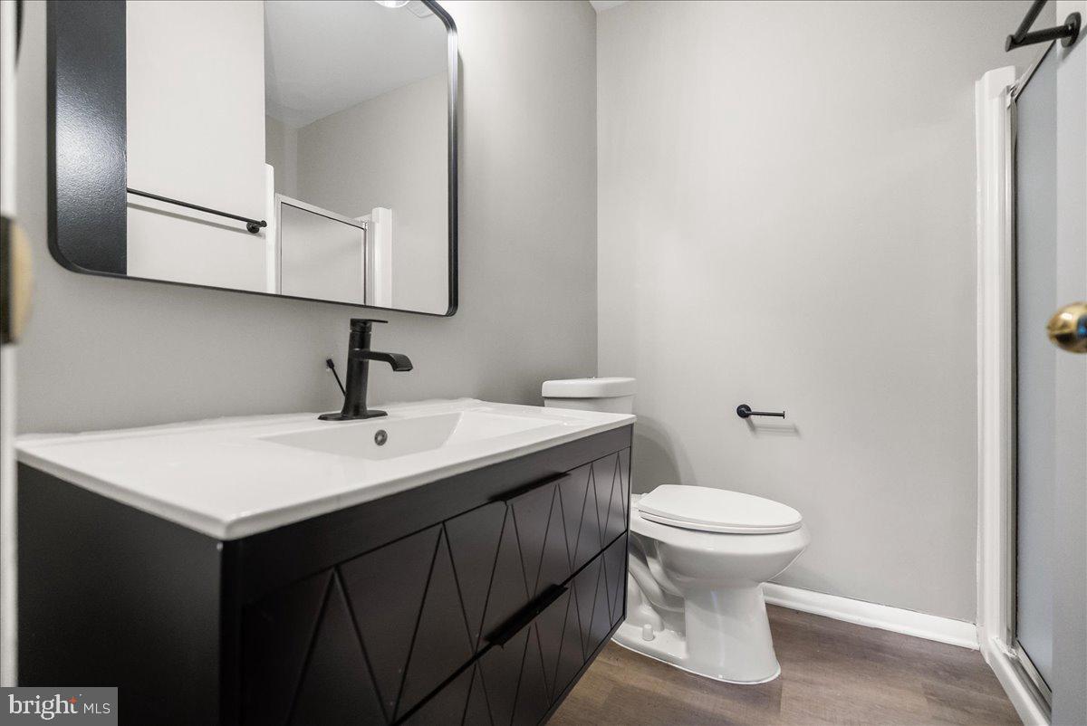 19030 Mills Choice Road, Unit 6 Gaithersburg, MD 20886 - Photo 19 of 21 a bathroom with a toilet sink and mirror